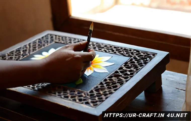 Home 17 수공예 유화 공예 - Photorealistic close-up of a skilled artisan hand-painting a small floral oil artwork on a stretched...